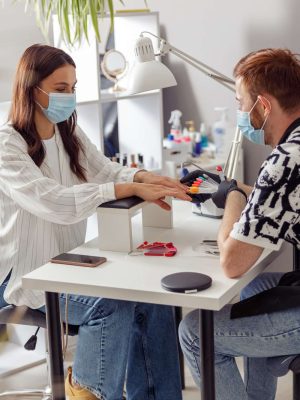 Happy attractive woman visiting nail beauty salon